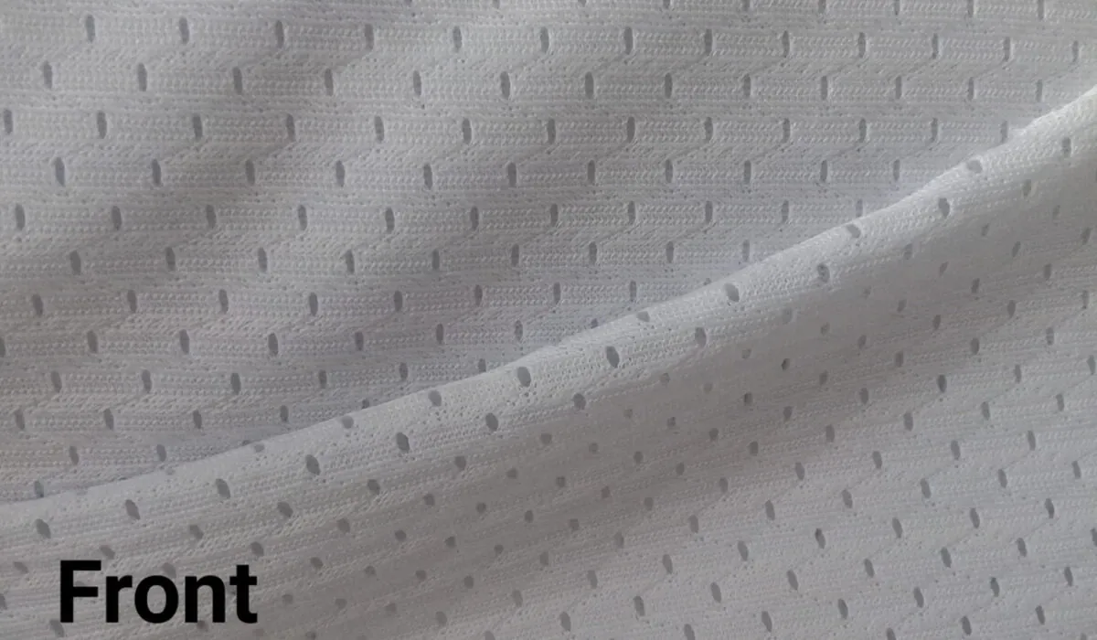 Close view of Microcool needle hole mesh fabric held up to the light
