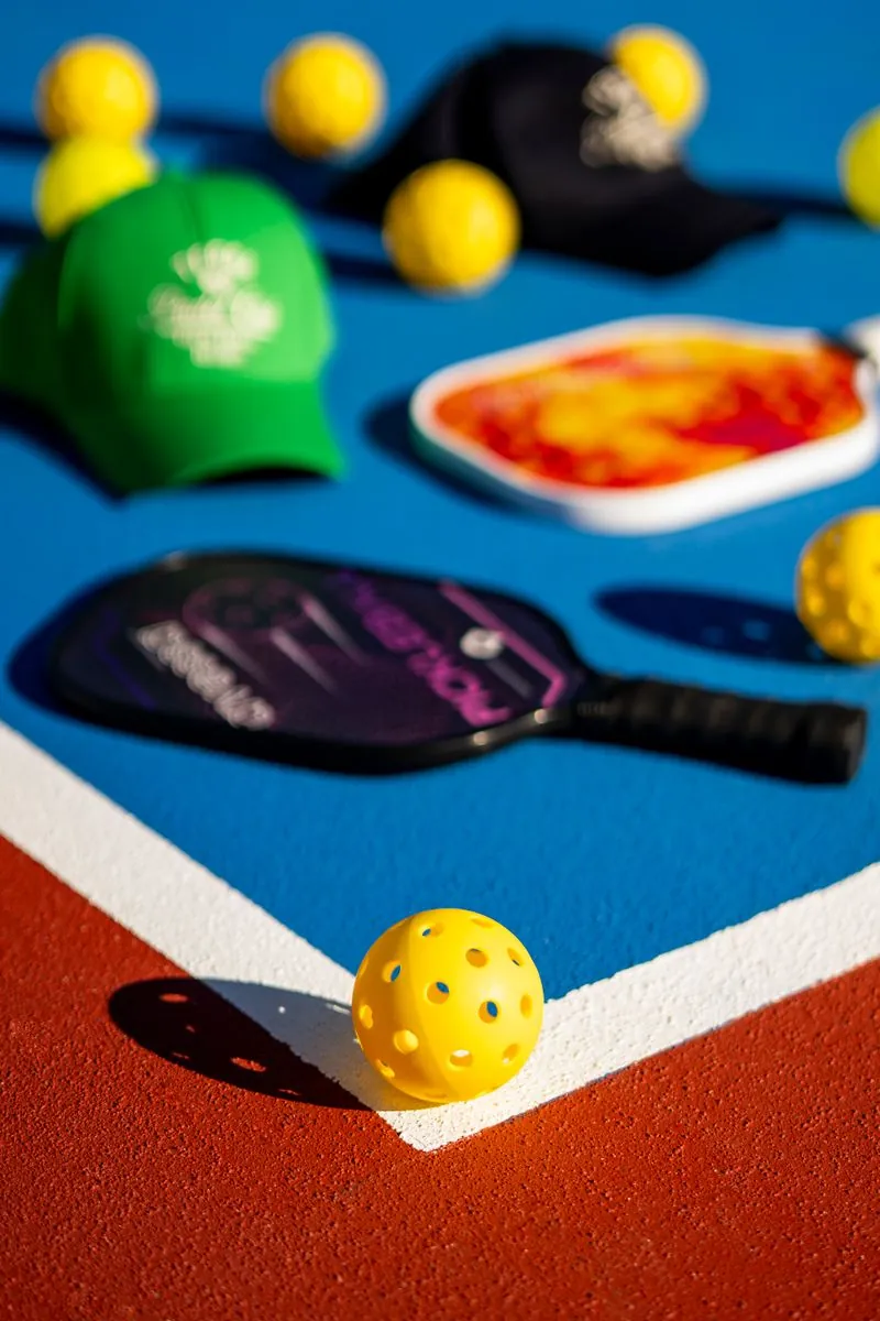 Pickleball paddles and balls on court