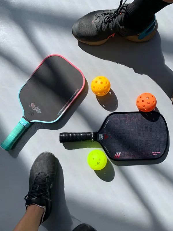 Two pickleball paddles on court