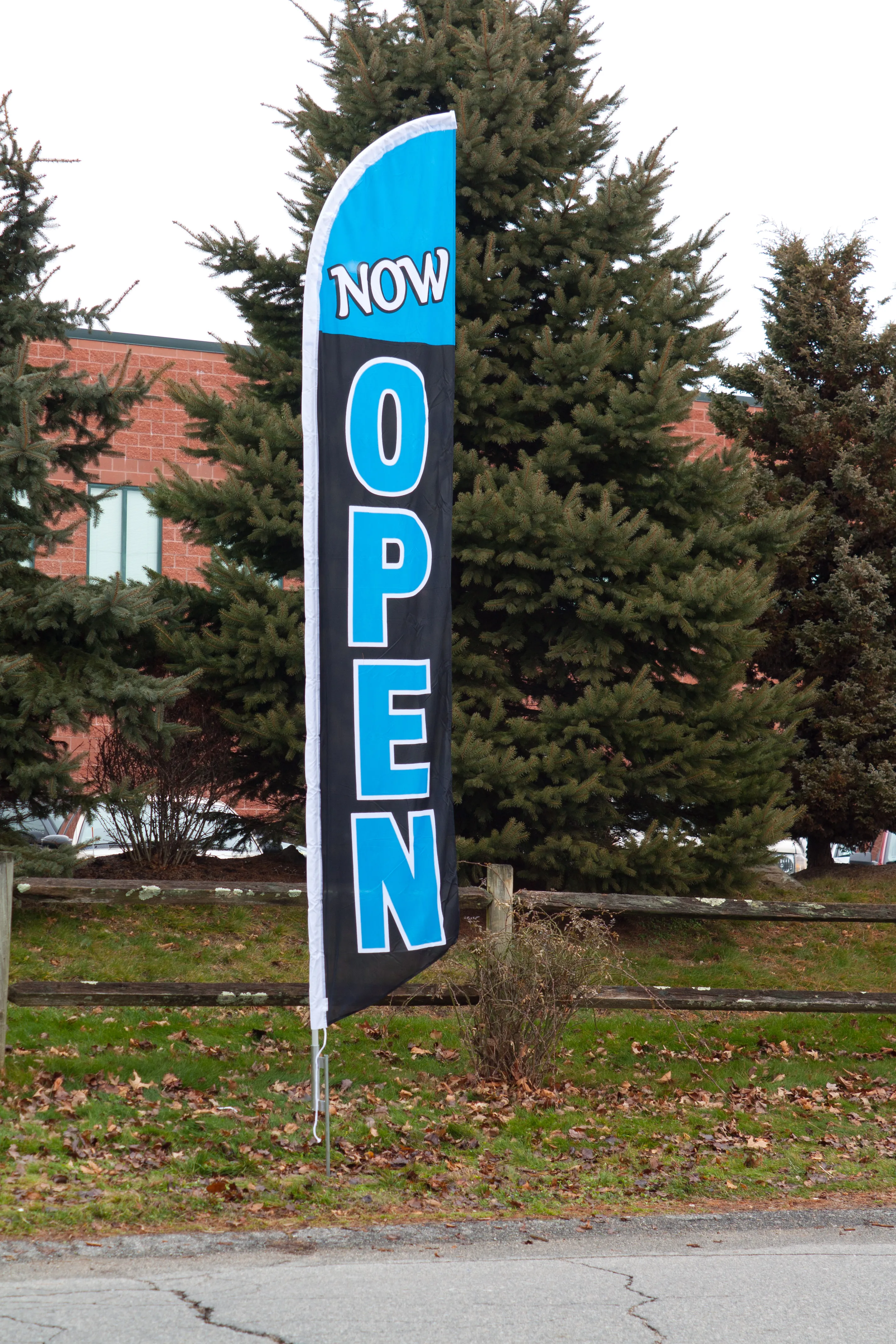 Now Open custom feather flags installed on an outdoor storefront