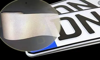 Close-up of reflective vinyl plate showing honeycomb reflective texture and lettering