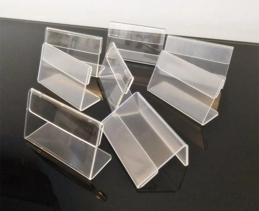 Acrylic price tag and wall label holders on a retail shelf