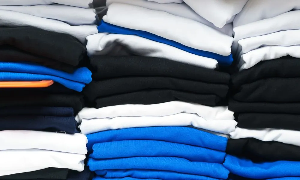 Folded blank t shirts in several colours stacked in bulk